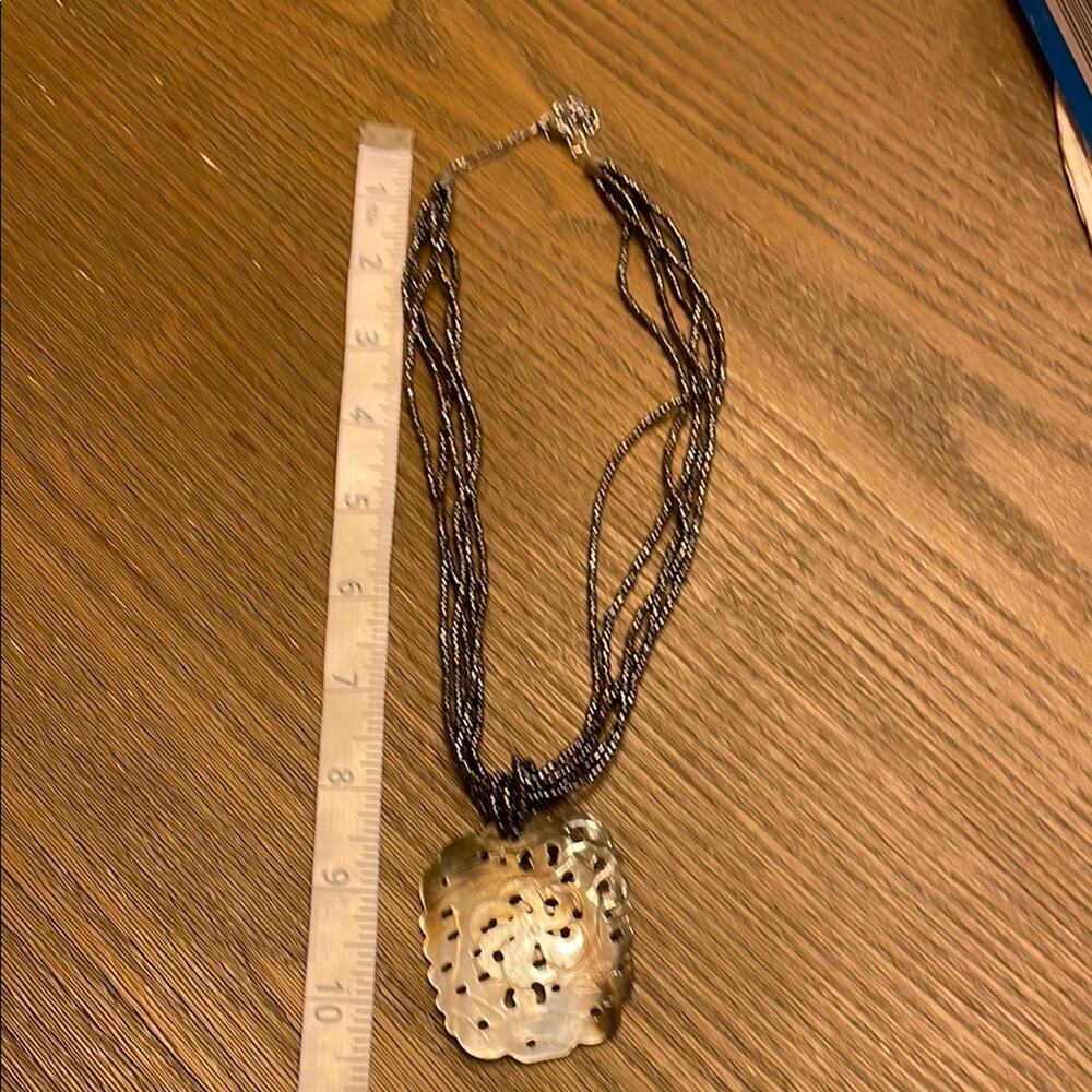 Browns multi strand  seed bead necklace with carved shell pendant